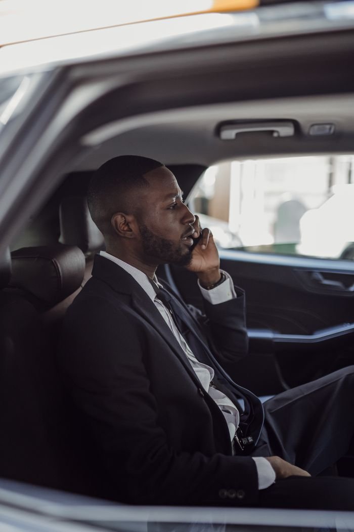 TLC Licensed Chauffeur opening car door for client in NYC